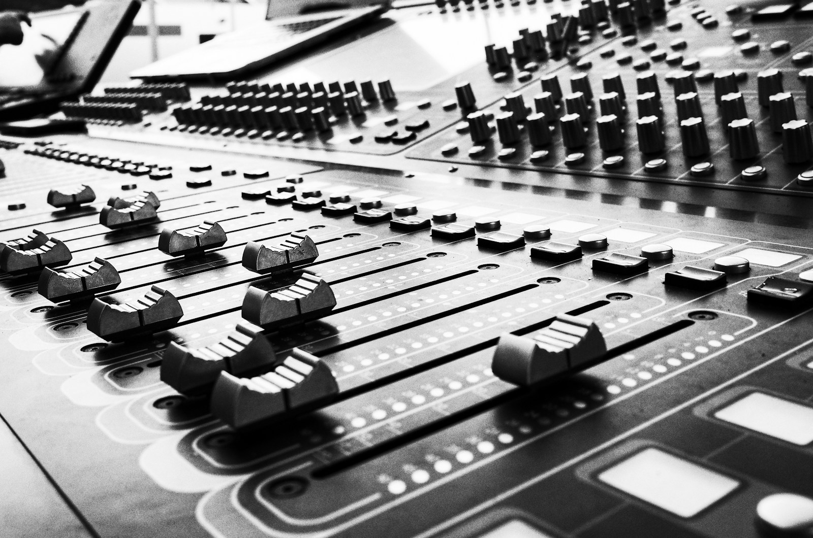 Close-up of an audio mixer console, representing the production quality difference between Instant and Professional ElevenLabs voice cloning