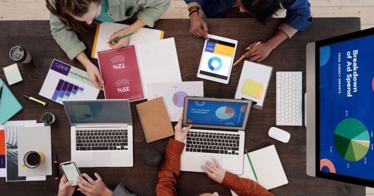 Marketing team reviewing AI-driven campaign performance charts together