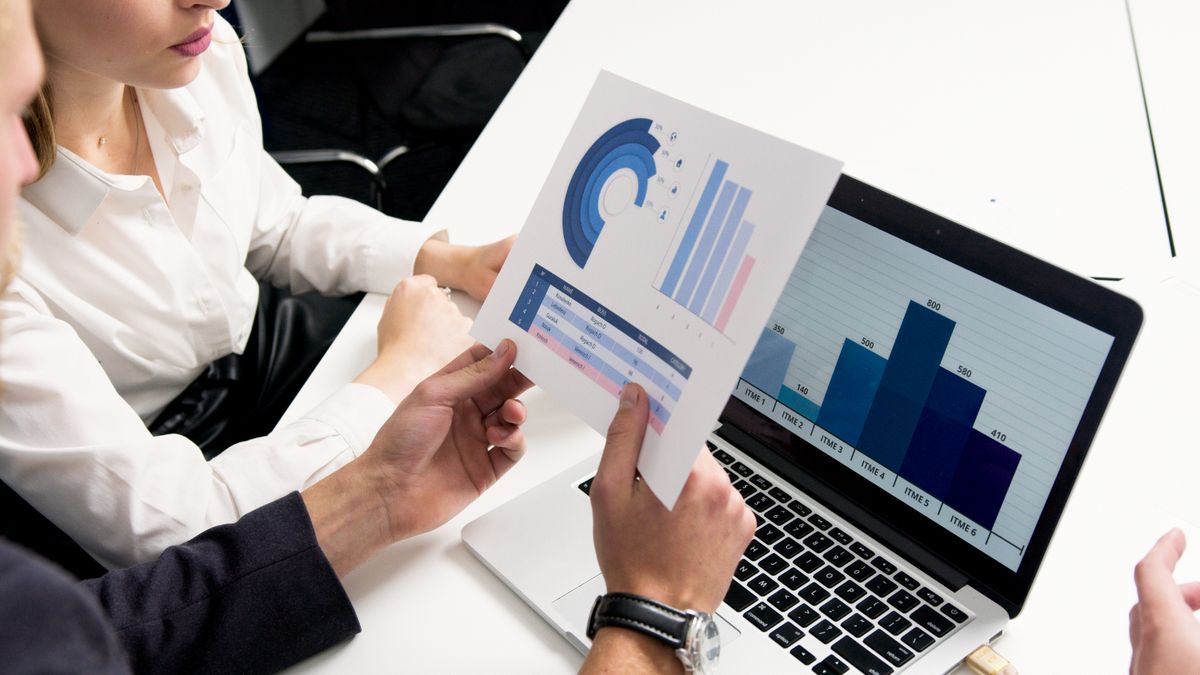 A person reviewing results and metrics on a laptop at a desk