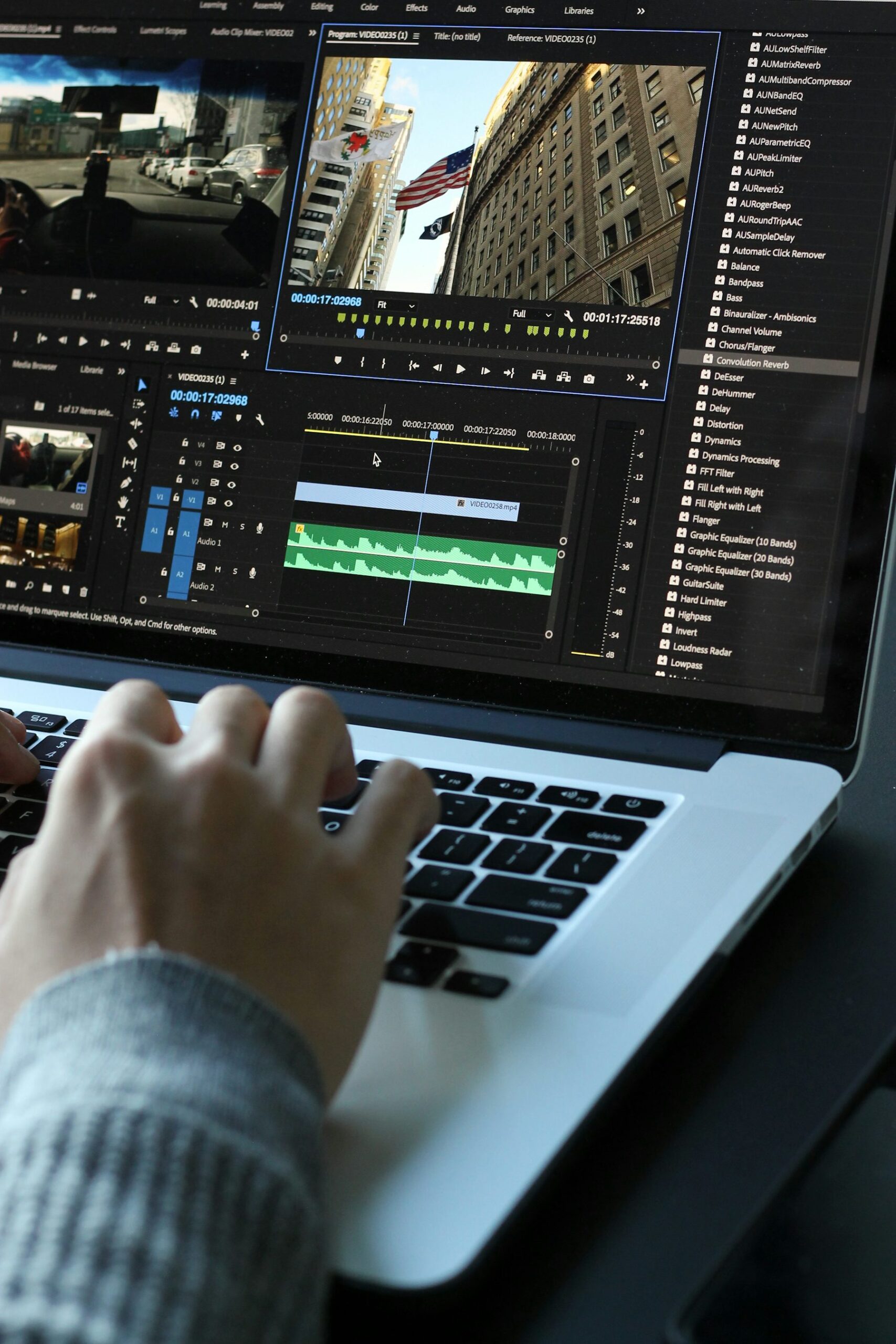 Video editor working on a laptop with a multilingual video timeline, representing AI dubbing and localization workflow