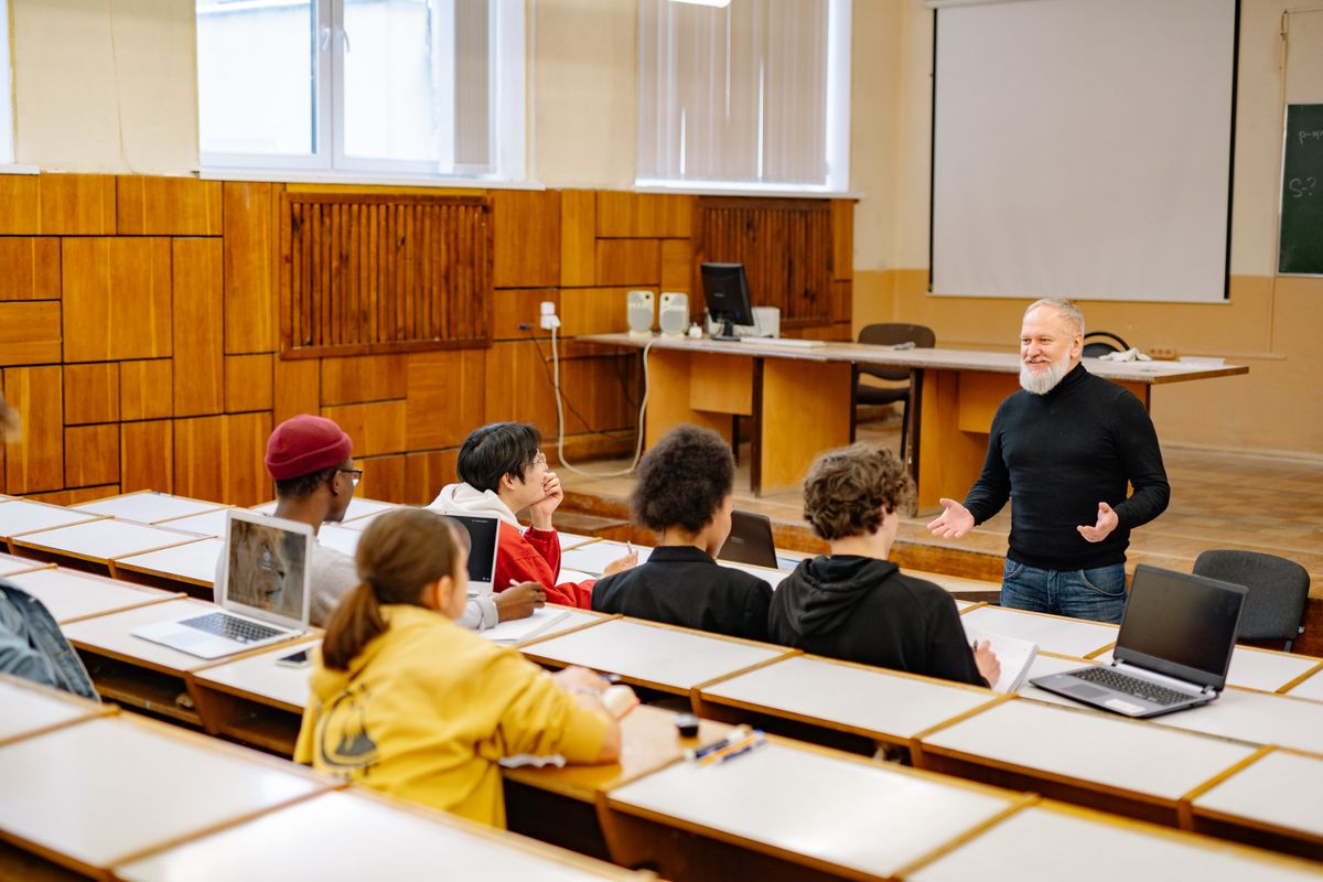 A teacher presenting a lesson from slides to students in a classroom