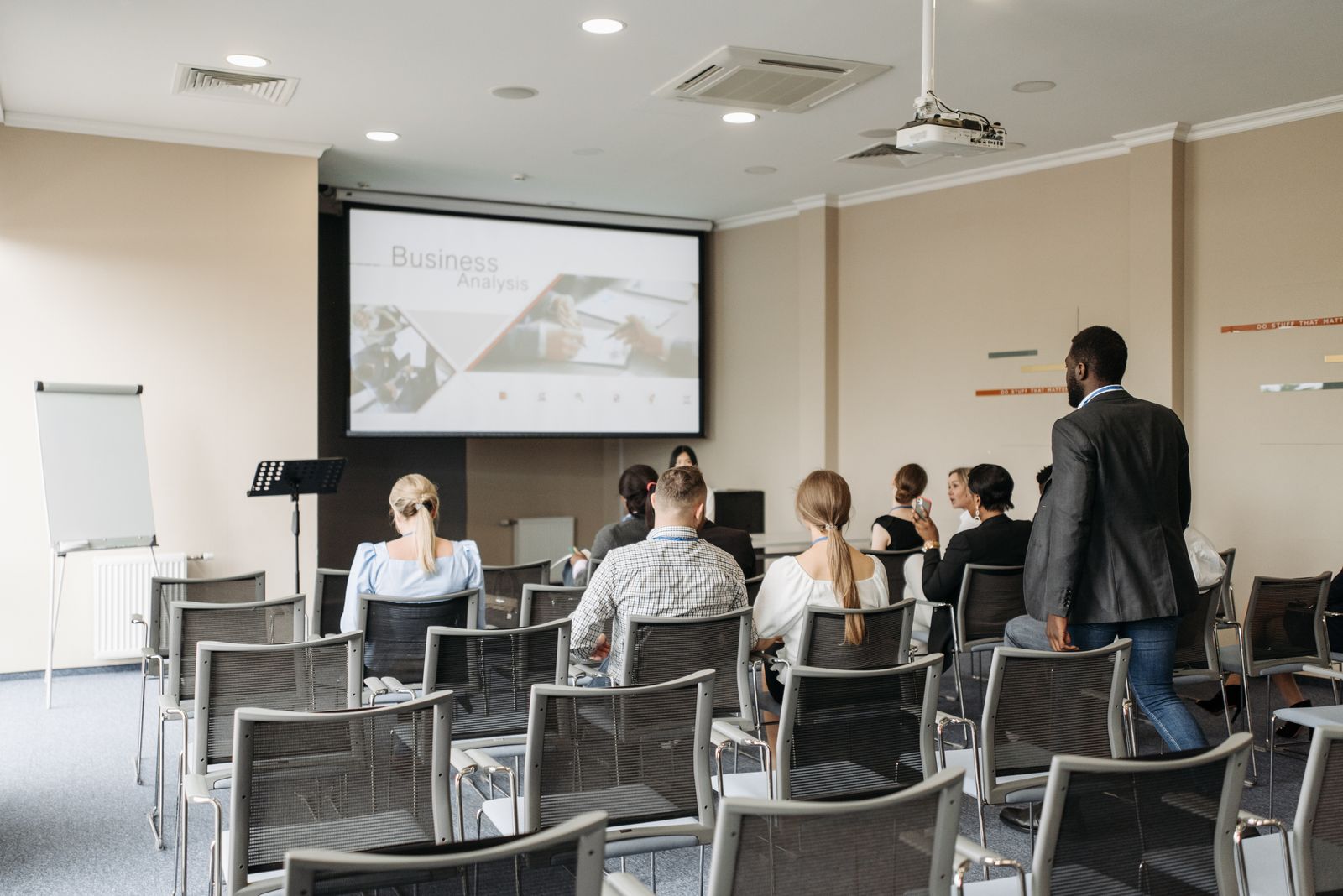 A presentation displayed on a large screen in a modern office