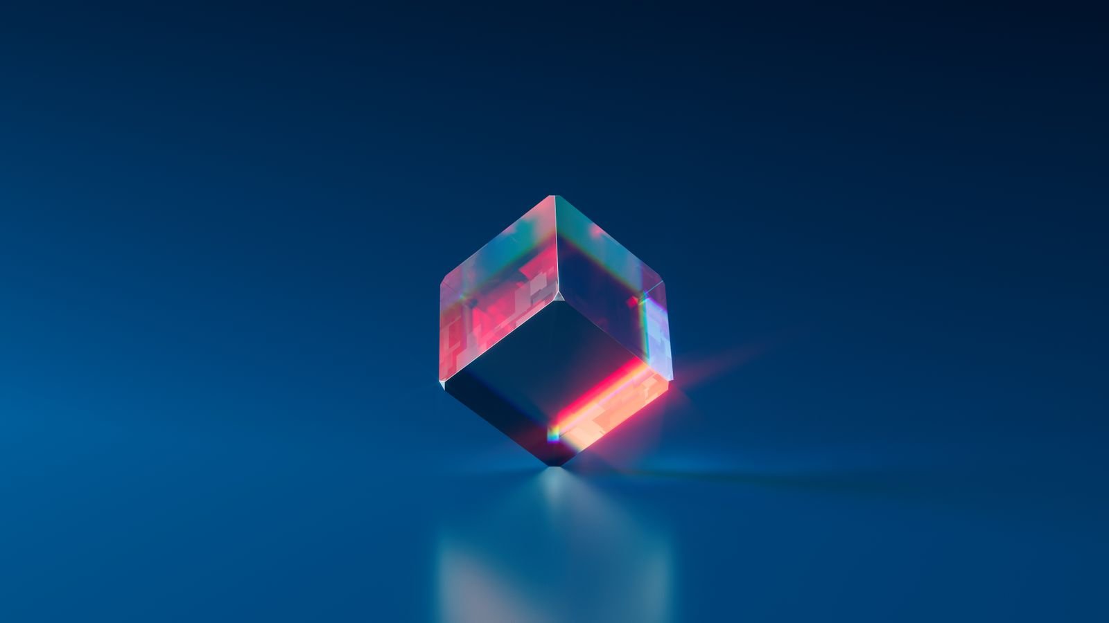 A glowing translucent cube render on a blue background