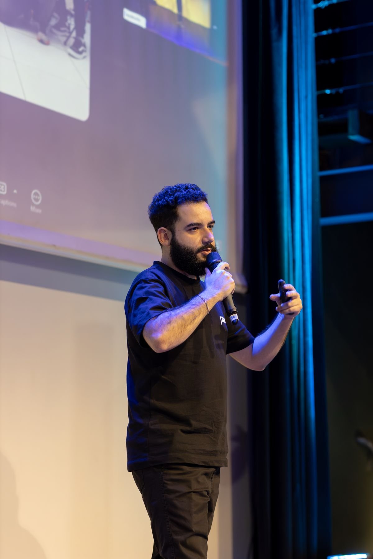 A founder presenting on stage at a demo day event