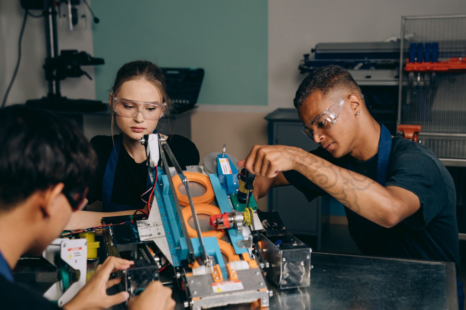 A group of students working together on a project around a laptop