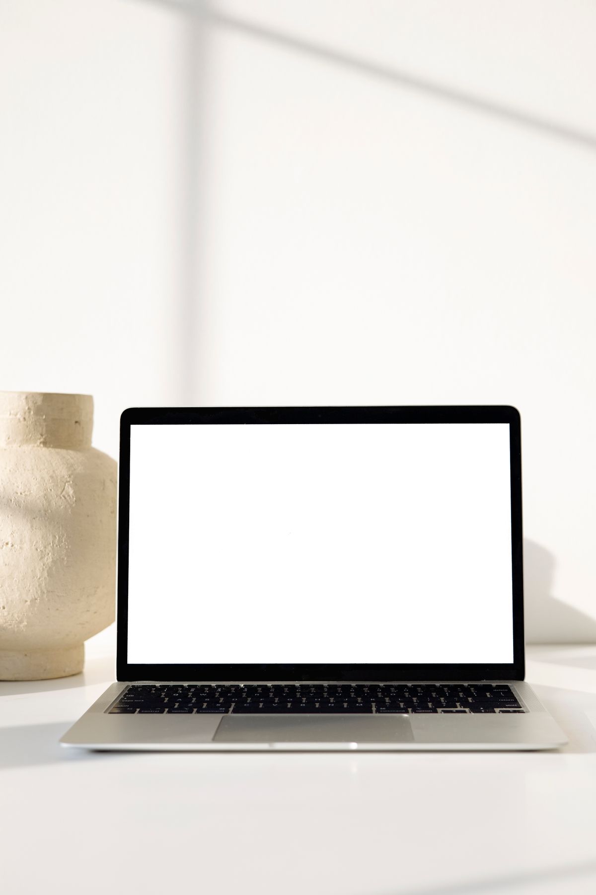 A laptop showing a presentation being built in Google Slides on a desk