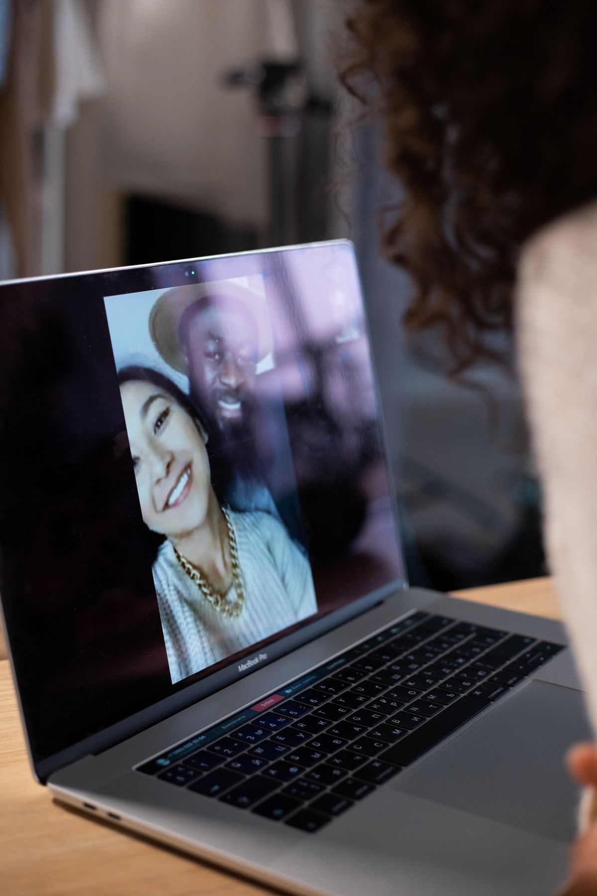 A person presenting a webinar to a remote audience on a laptop