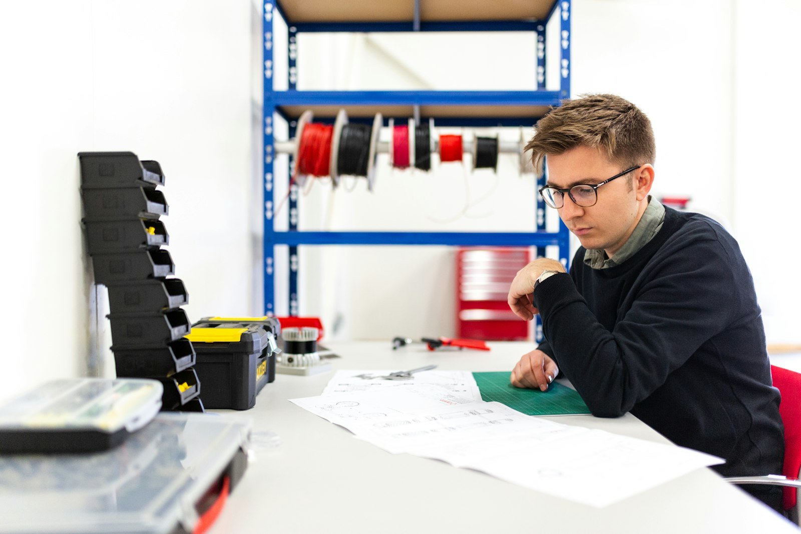 Engineering student working through problems on paper at a desk