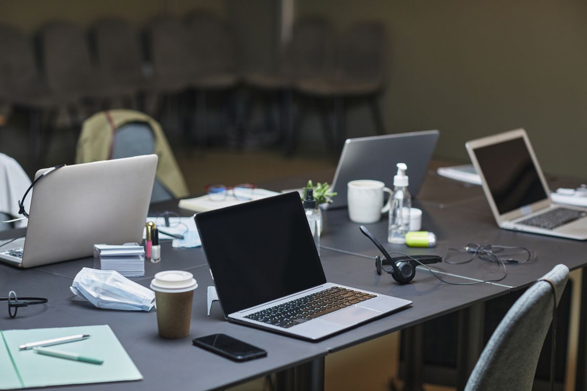 A laptop showing an AI workspace with multiple tasks open