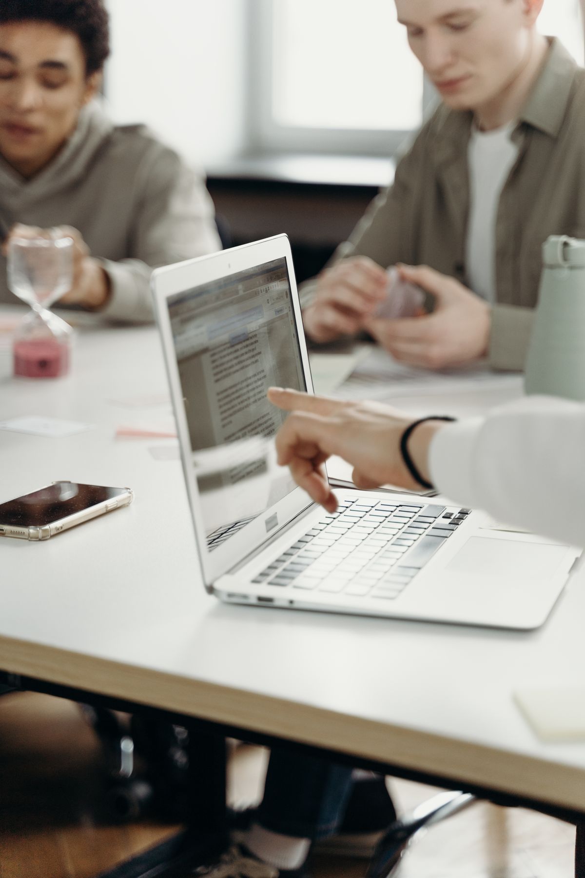 A person reviewing presentation slides on a laptop at a desk