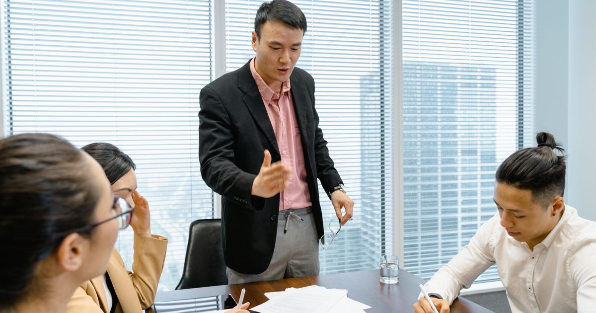 Consultants discussing strategy around a boardroom table