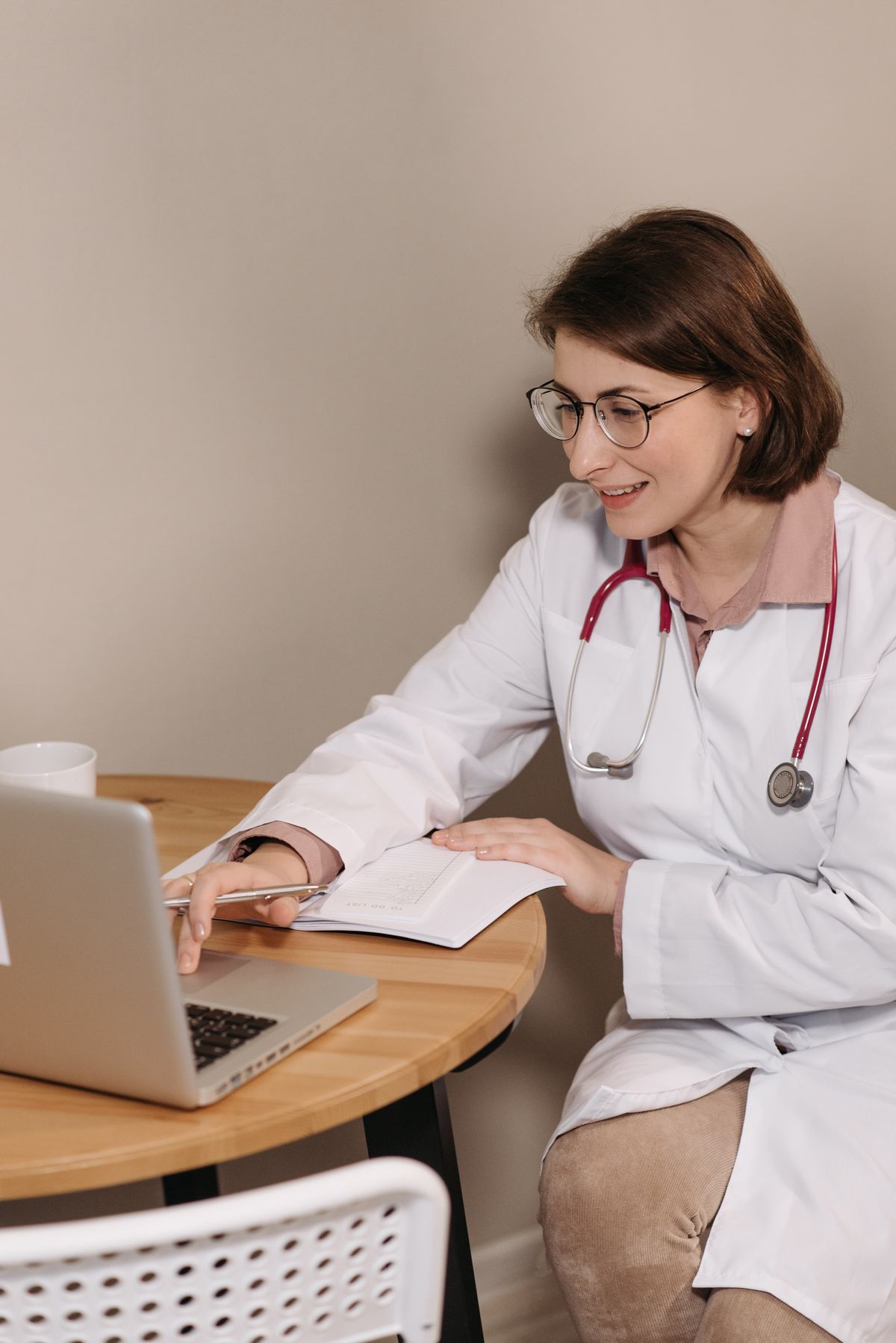 A medical student studying and preparing a presentation on a laptop