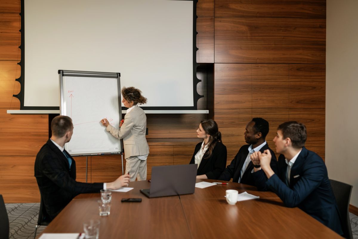 A business team reviewing a presentation together at a boardroom conference table