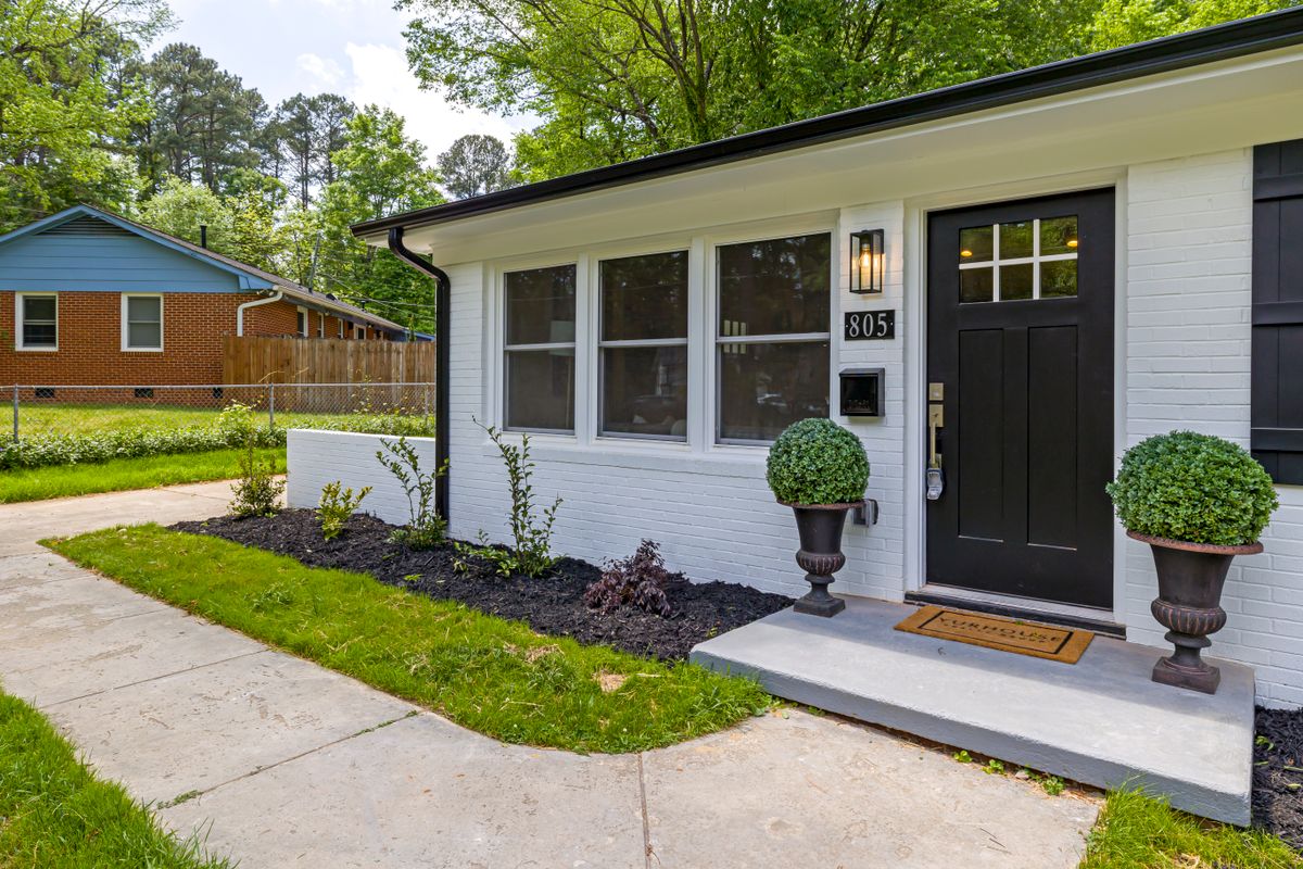 Modern suburban house exterior with a landscaped front yard ready for a real estate listing