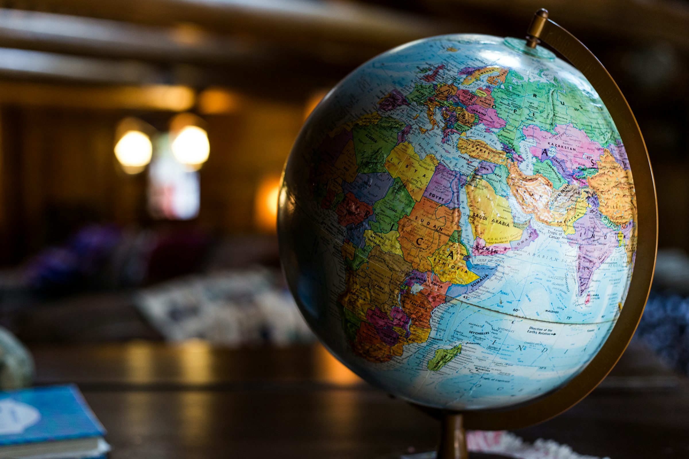 Desk globe representing global language coverage for multilingual AI voice generators