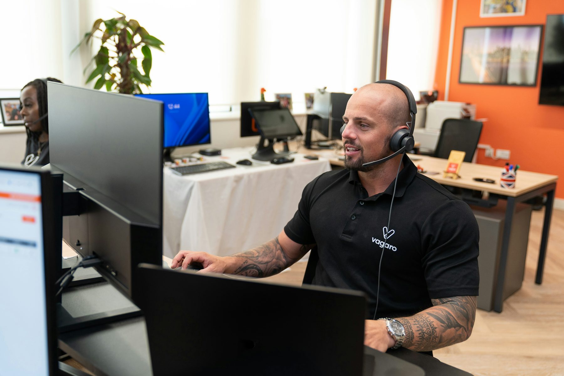 Call center agent working at a computer workstation with a headset, representing AI-assisted call handling