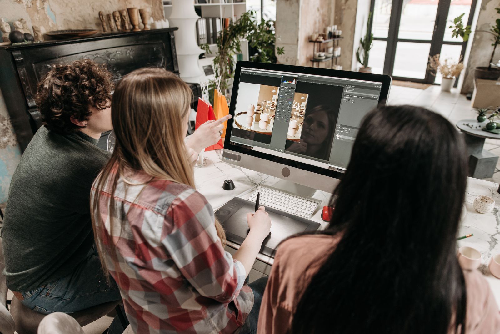 A creative team collaborating on design work around a table