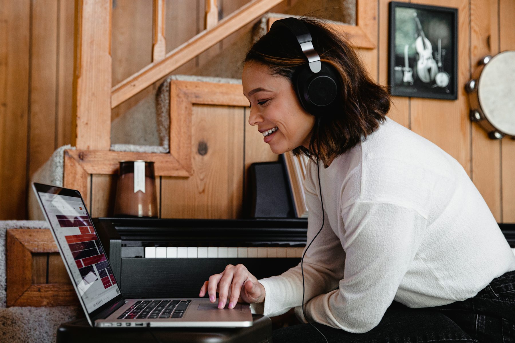 Course creator working on a laptop, reviewing AI voice narration for an online course