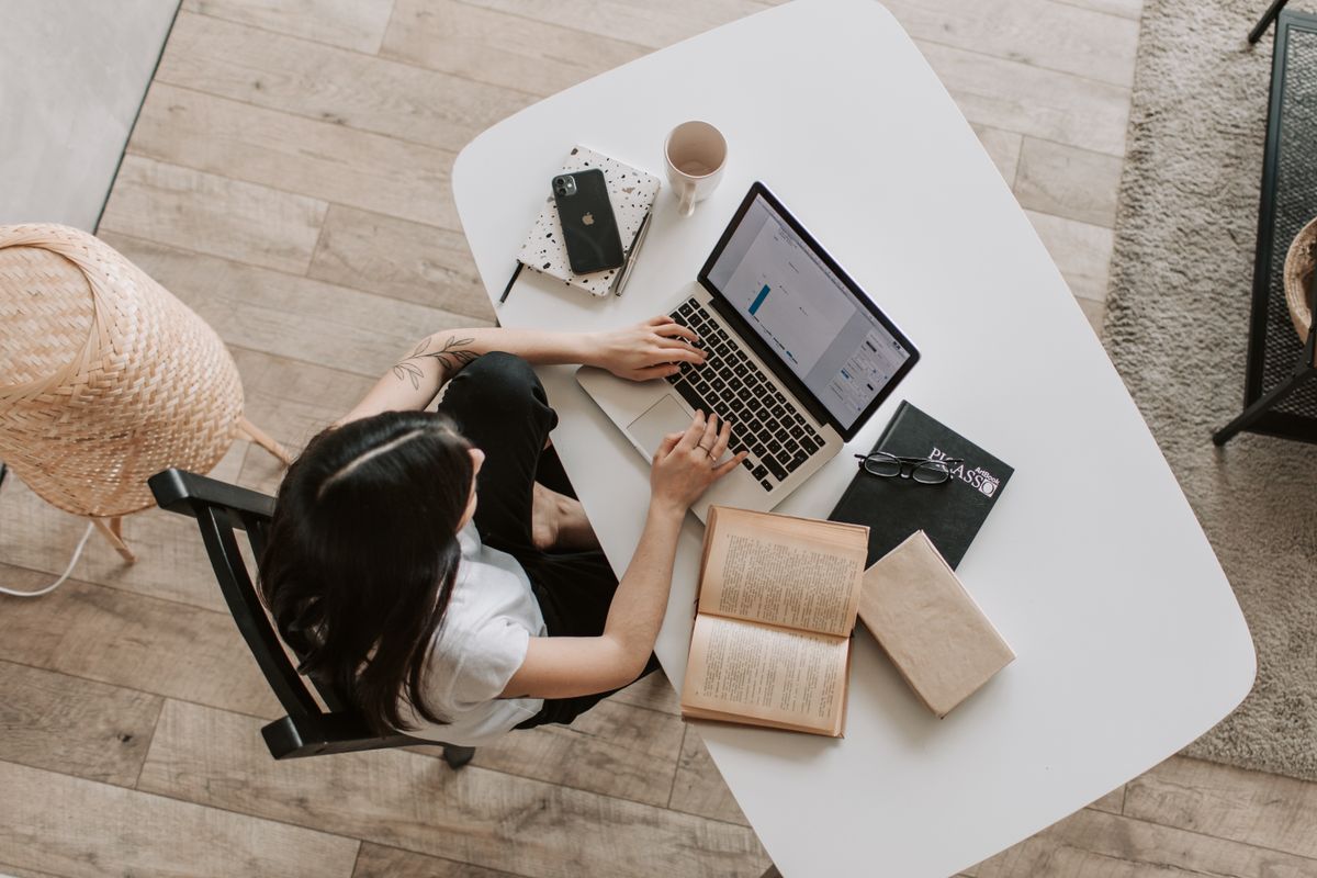 A freelancer working on a presentation at a laptop in a home office