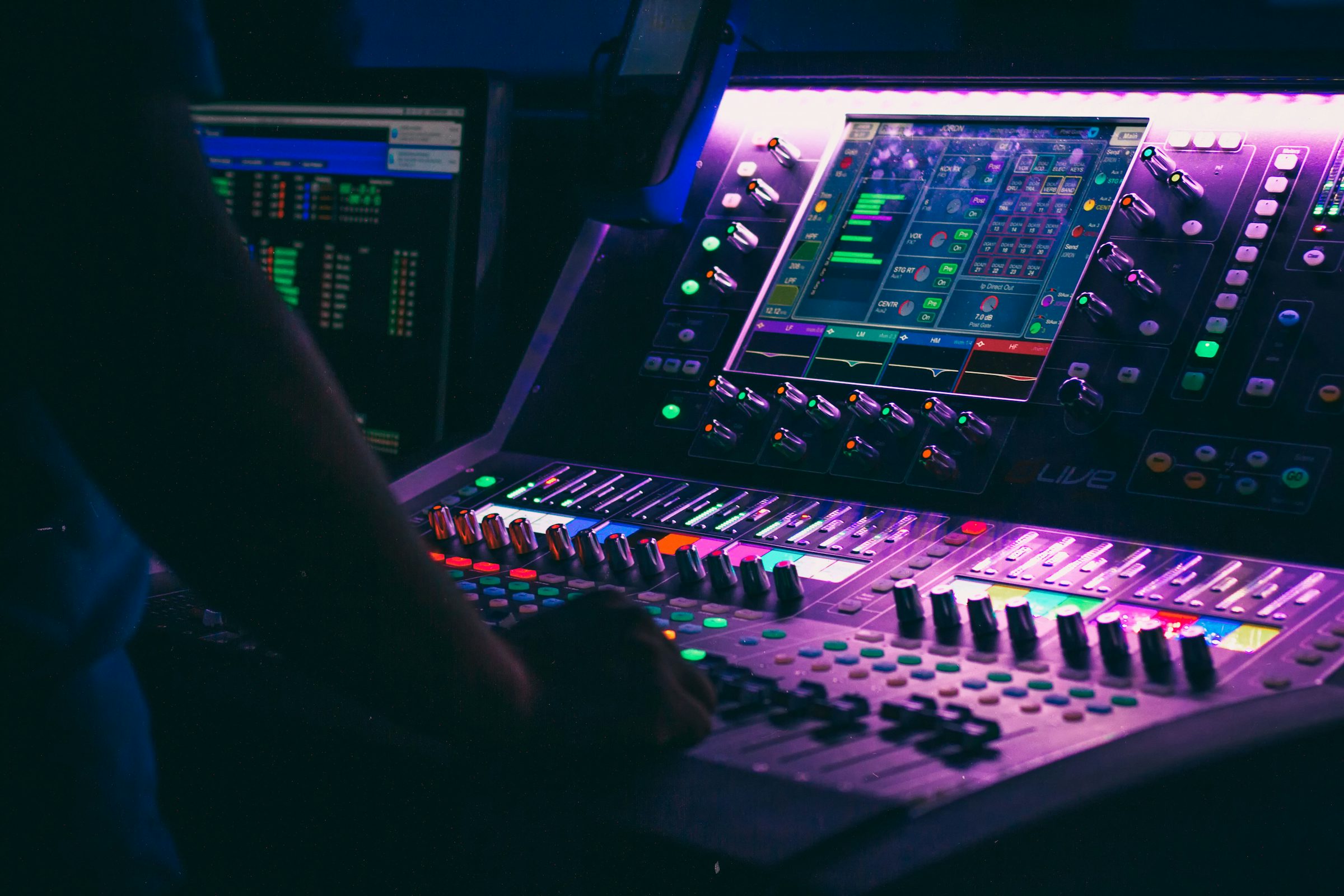 Person adjusting an audio controller, representing AI voice generation and emotional speech synthesis