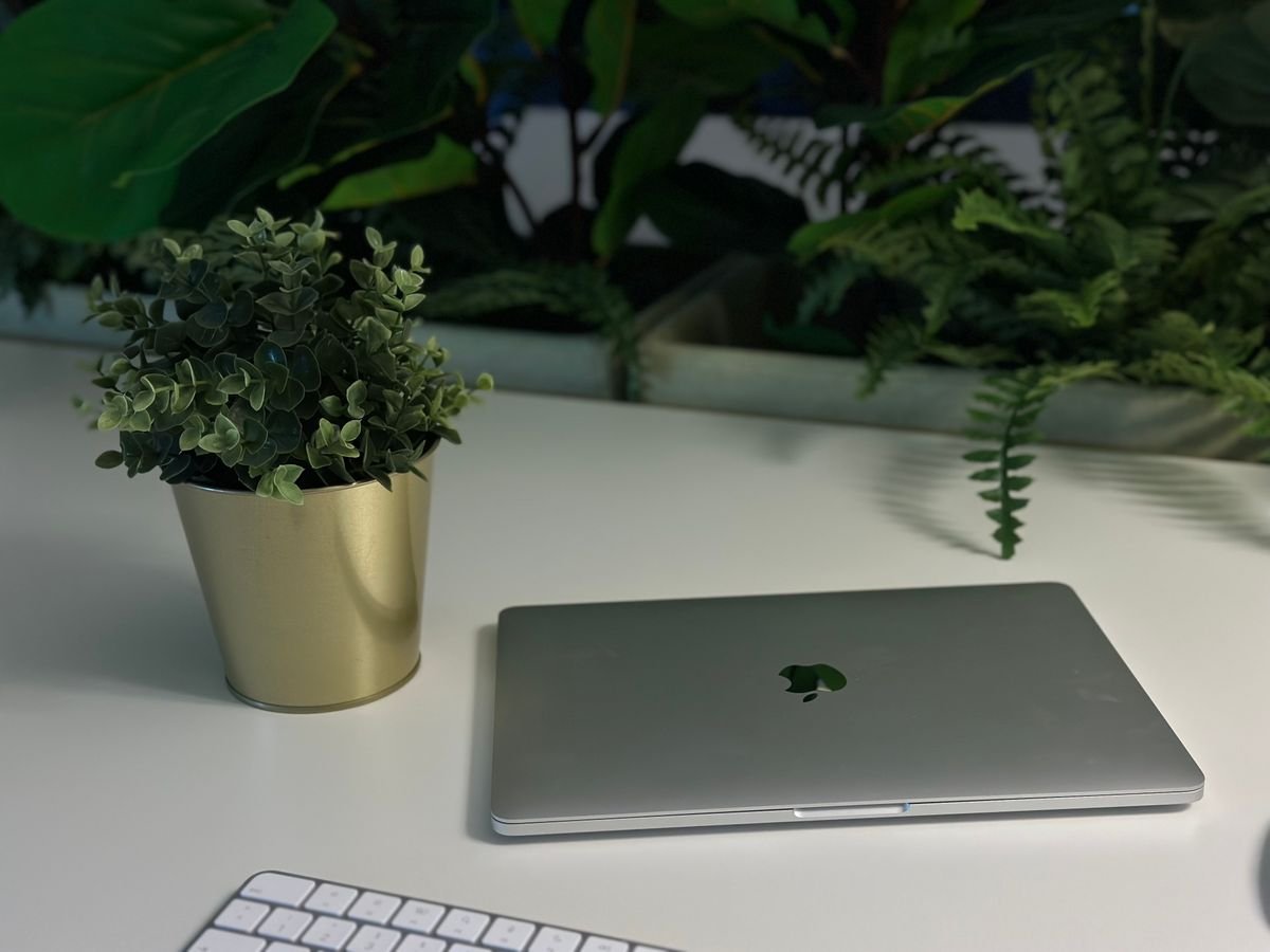 A clean minimalist workspace with a single laptop and white space