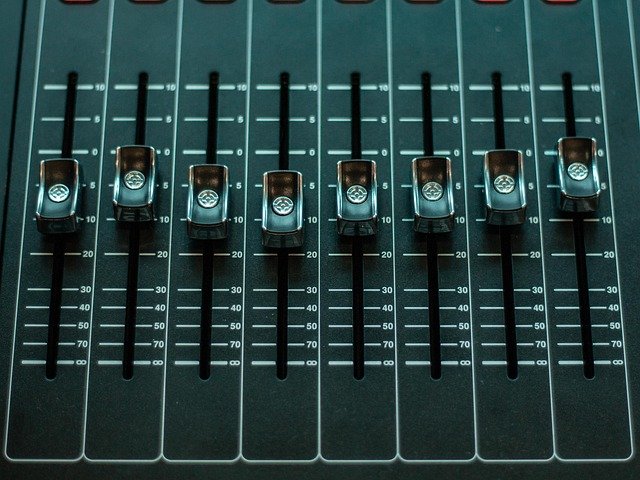 Close-up of a mixing console fader in a music studio