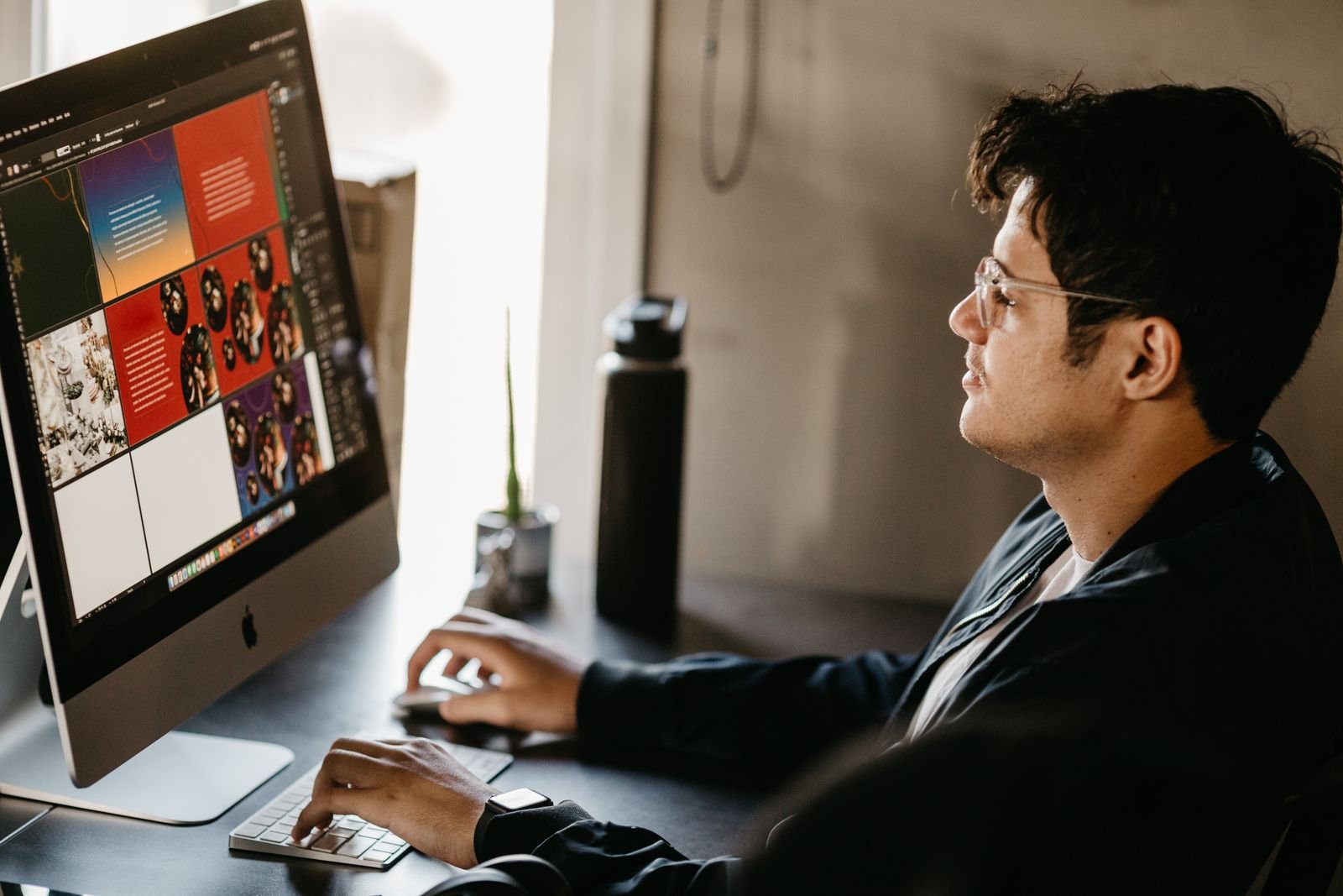 A designer working on colorful slide layouts on a desktop screen