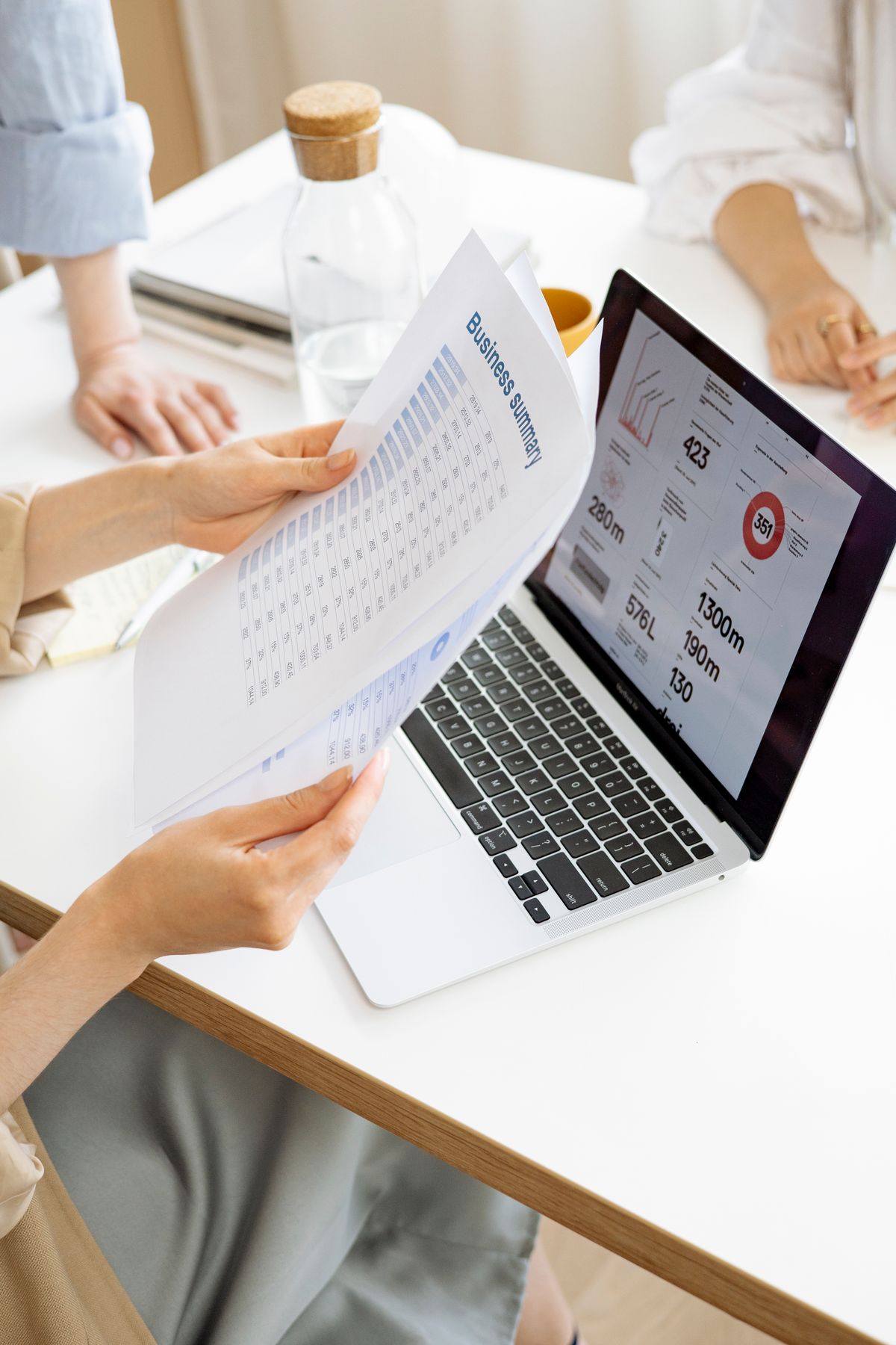A laptop showing a long document being condensed into slides