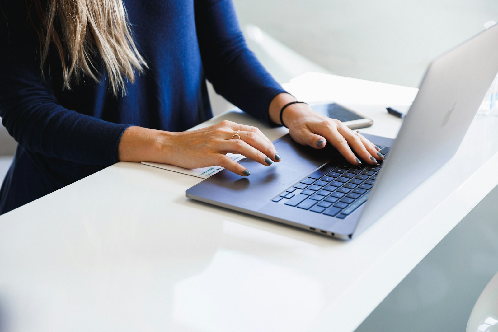 Woman using a laptop to review AI presentation software