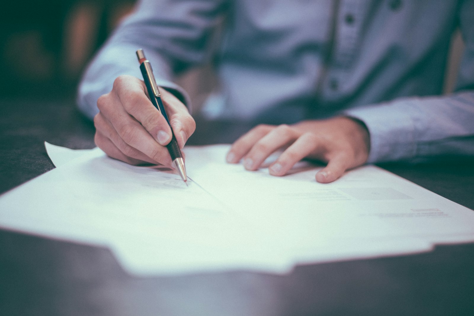 Person reviewing terms and pricing details before signing up for a service