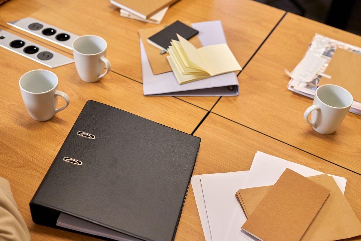 Documents and papers on a desk, ready to be distilled into a presentation
