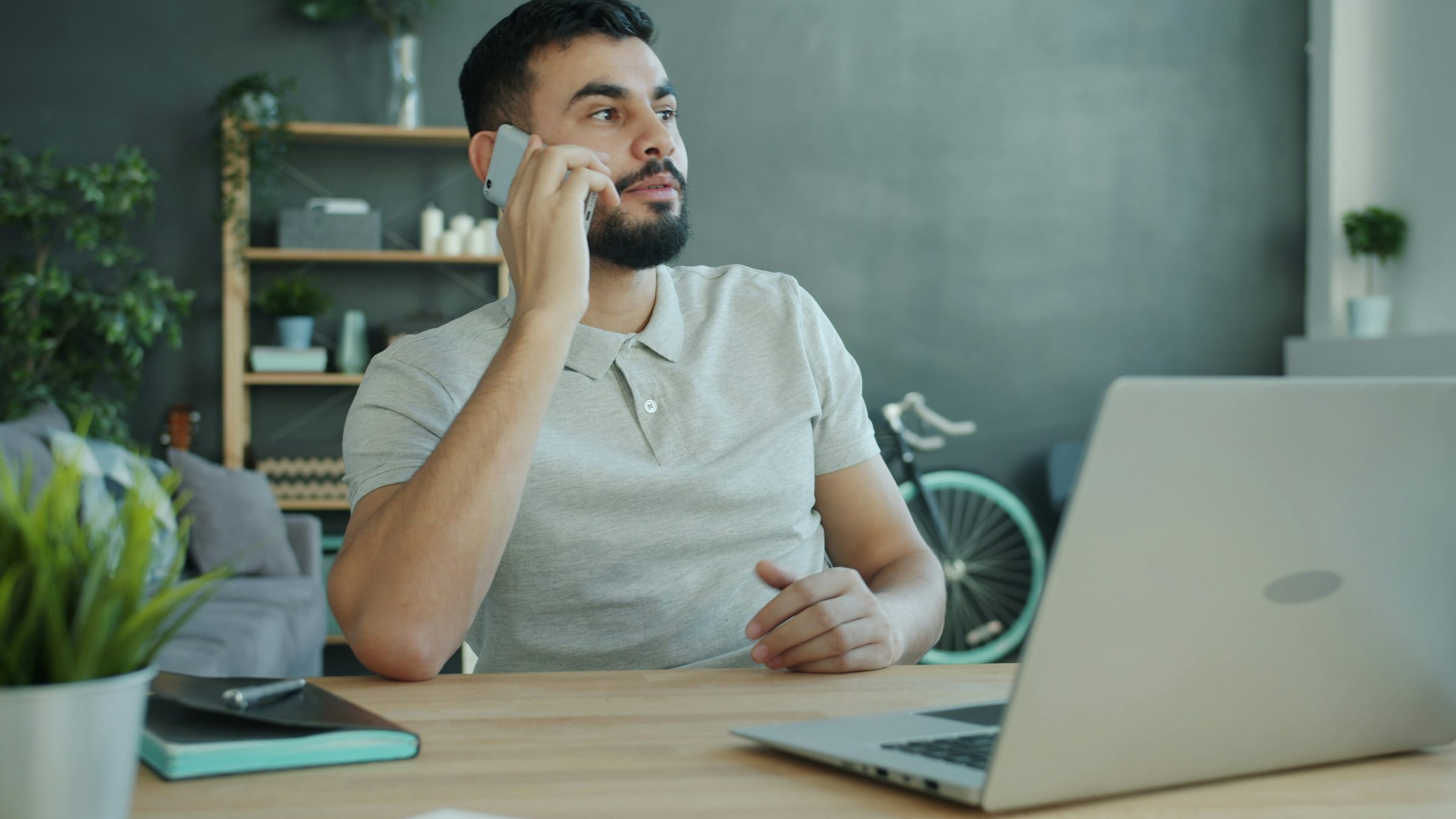 Person on a phone call at a desk, representing an AI voice agent handling business calls