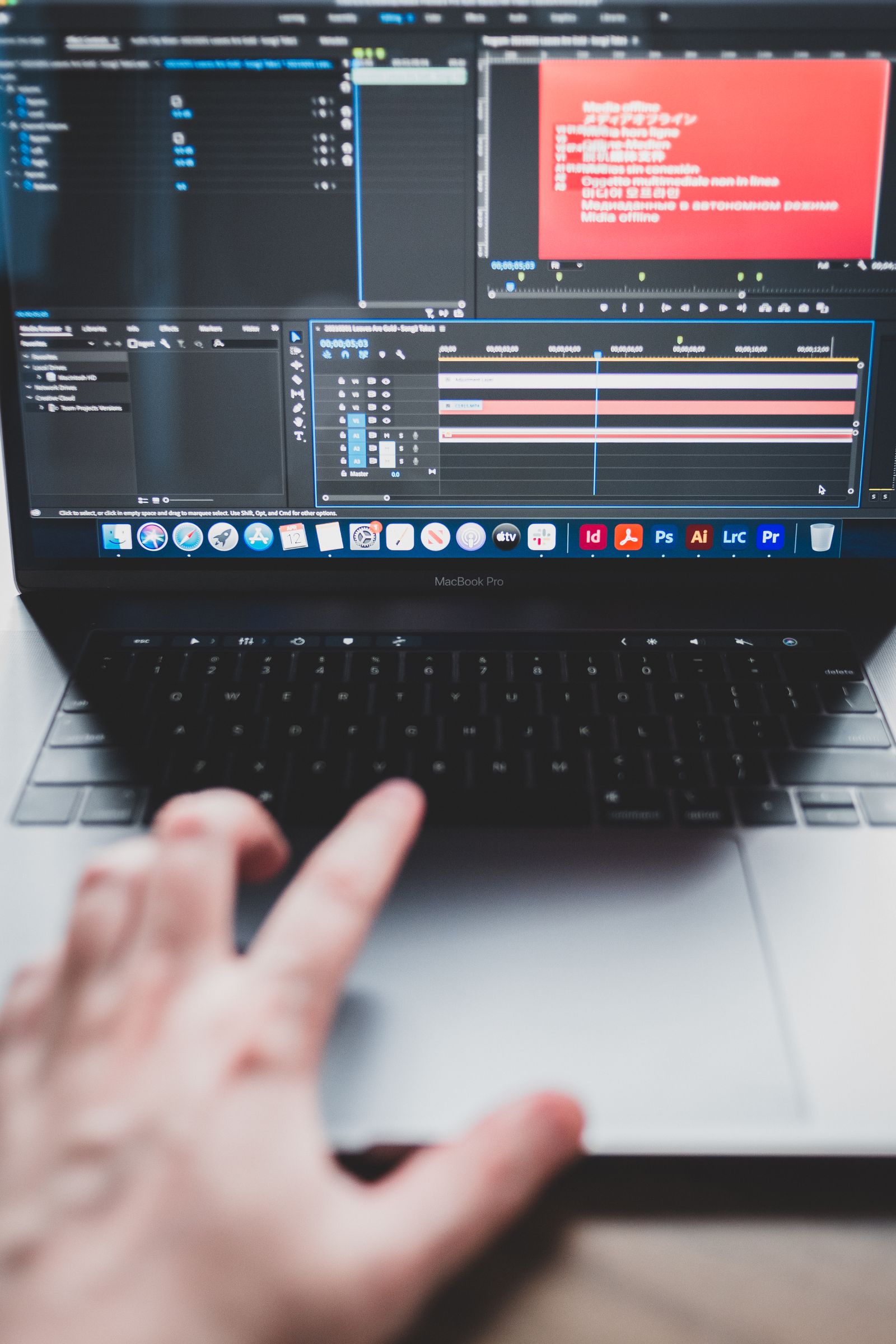 A laptop showing video editing software with a timeline on screen