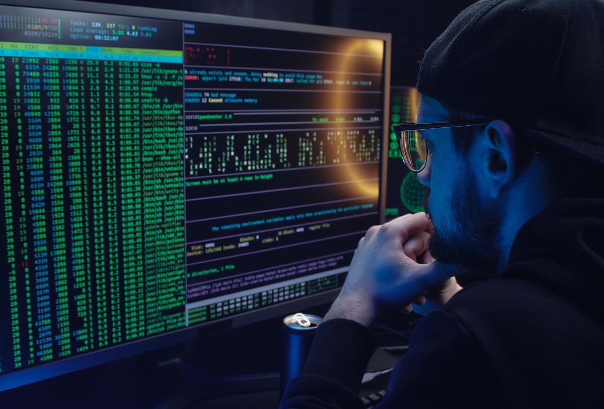 An engineer studying dense numerical data on dual computer monitors