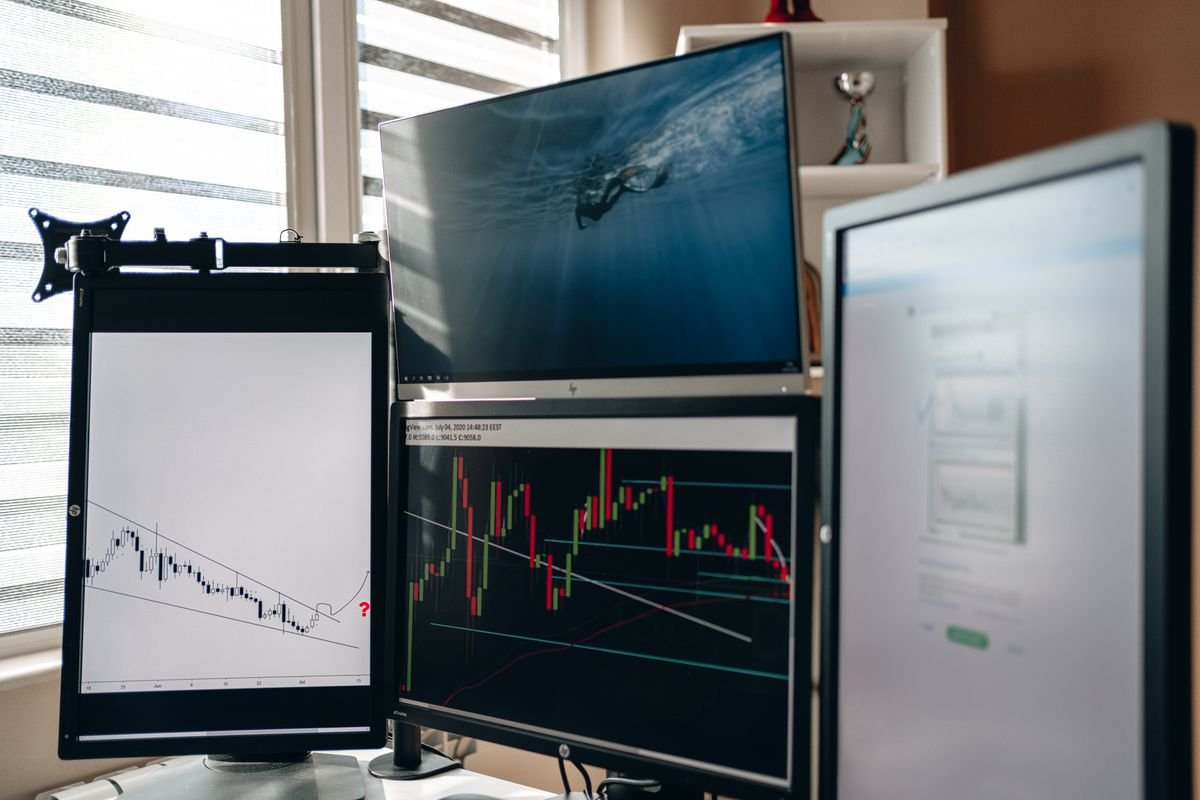 Colorful graphs and analytics charts displayed across computer monitors