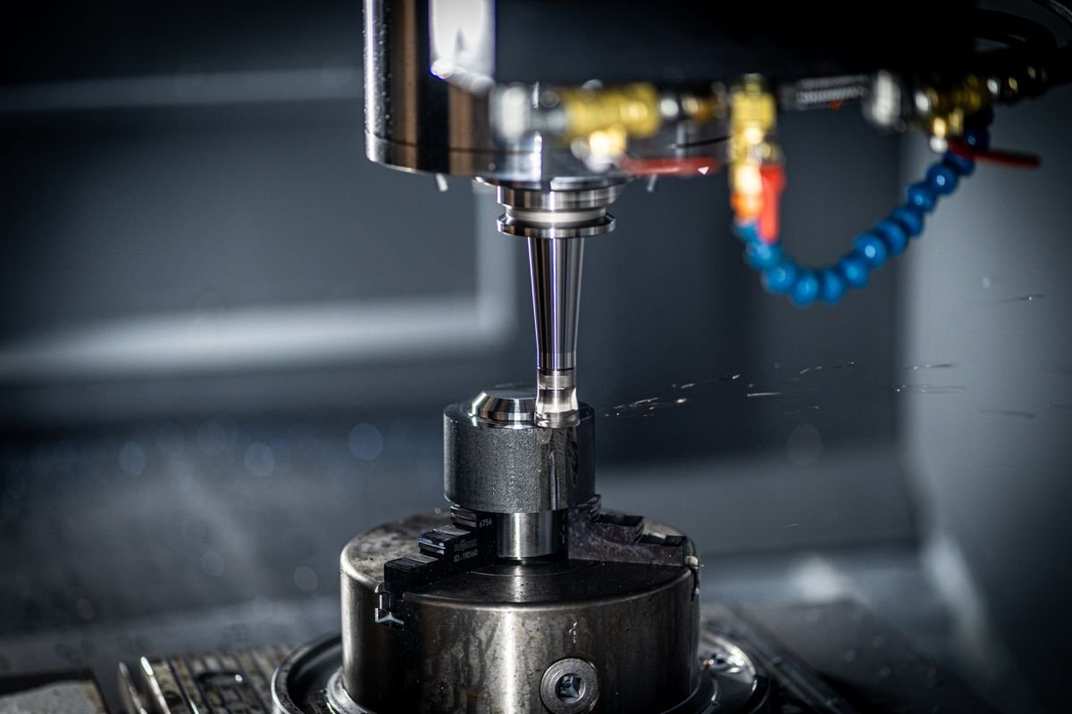 A CNC machine cutting a metal part during precision manufacturing