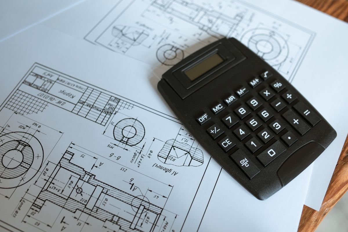 A calculator resting on construction blueprints during a quantity estimate