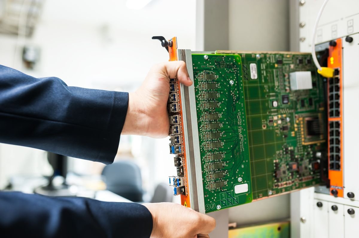 An engineer servicing a core switch in a data center where enterprise AI data is stored