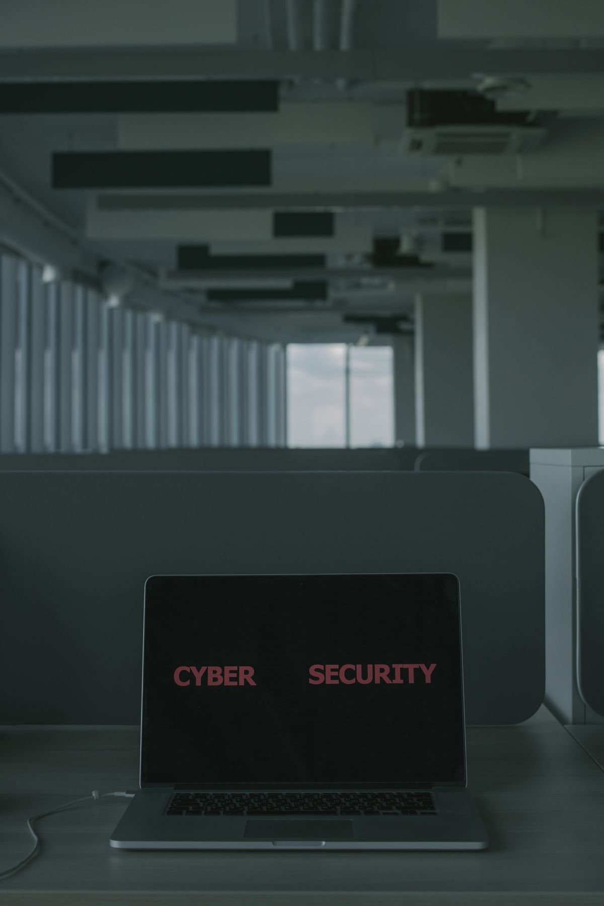 A laptop screen displaying cyber security text, illustrating protection of engineering data in AI tools
