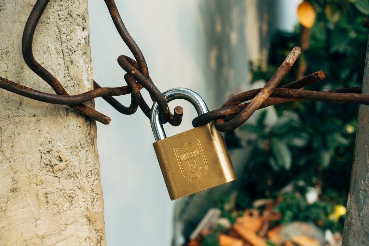 A closed brass padlock resting on a laptop keyboard, representing AI tools that keep your data private and do not train on your inputs