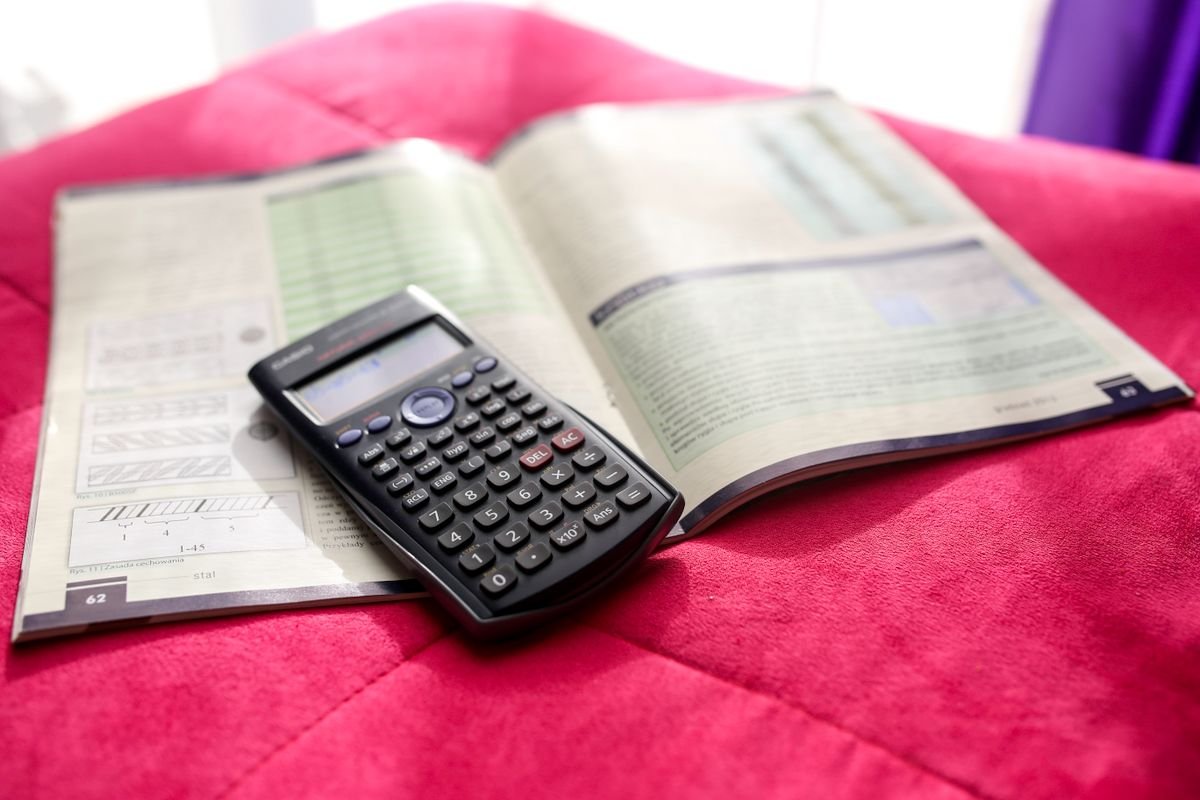 A scientific calculator resting on an open engineering textbook