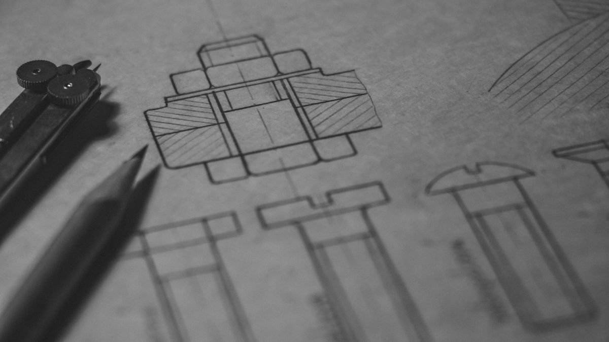 A technical engineering blueprint with a pencil and drafting compass illustrating design detail