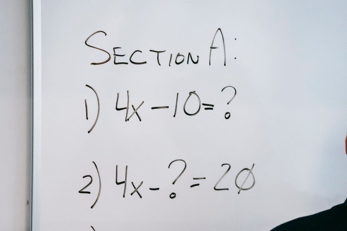 Engineering equations written across a whiteboard during a problem-solving session