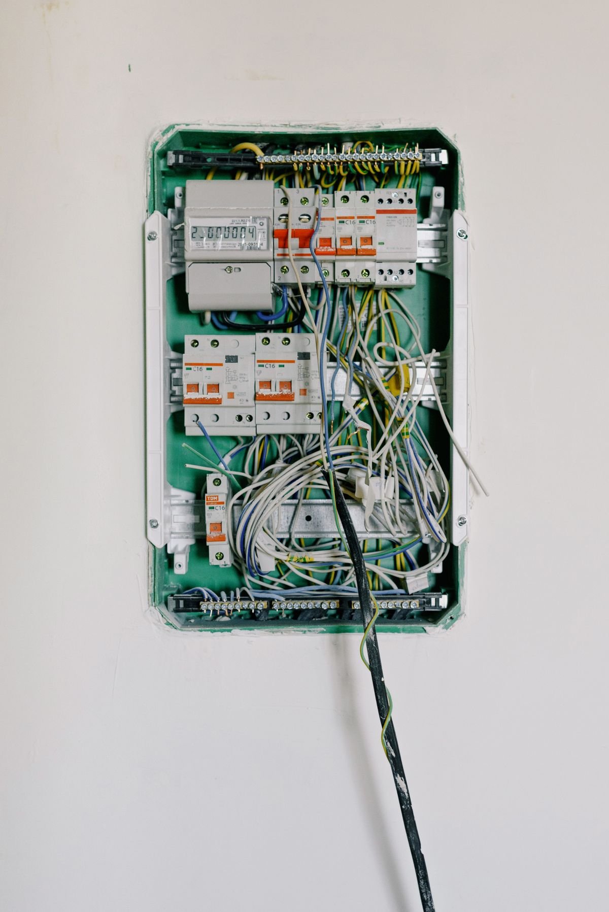 Open electrical circuit box with complex wiring and circuit breakers