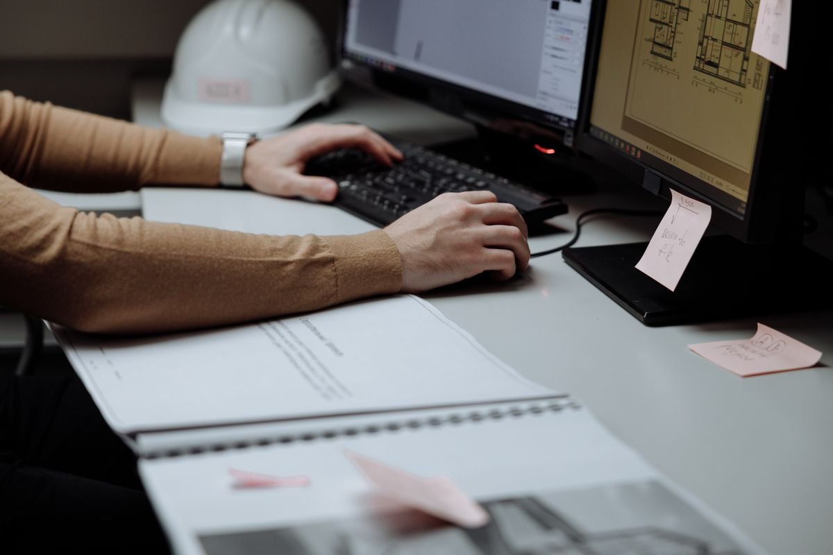 Engineer working at a dual-monitor CAD workstation