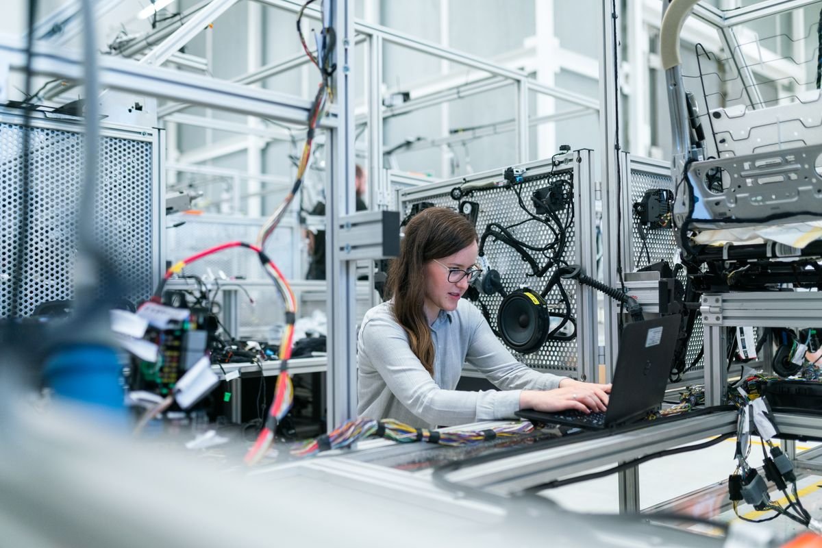 An engineer working at a laptop in a modern workspace using free AI tools