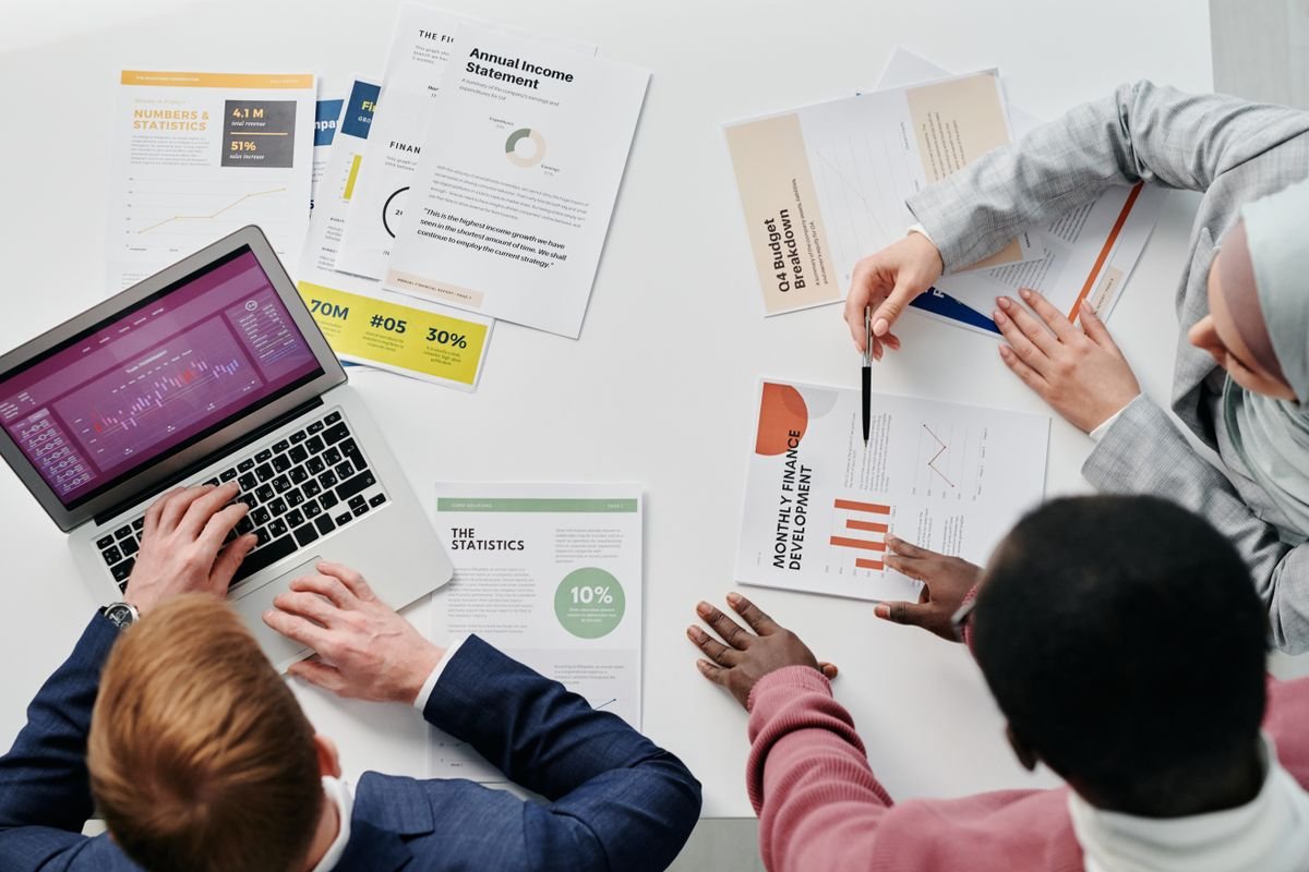 A team reviewing printed budget documents together in a meeting