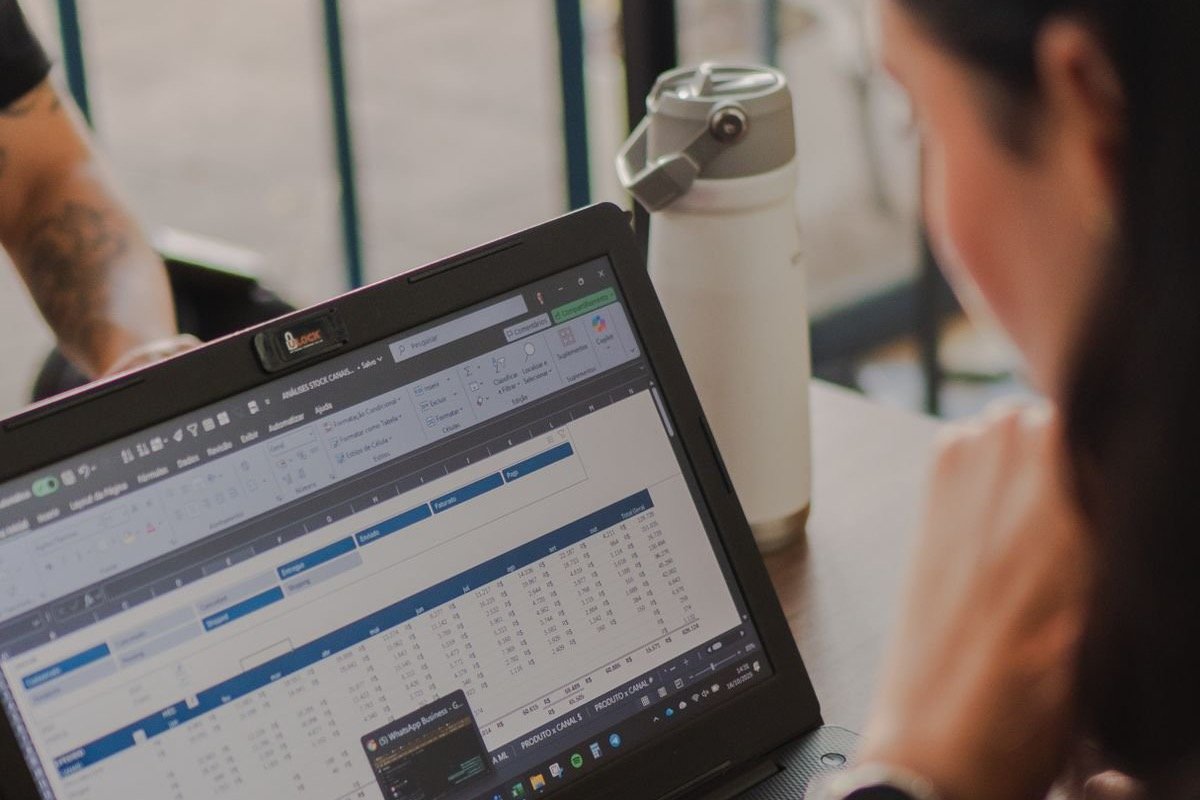 An engineer reviewing spreadsheet data on a laptop screen at a desk