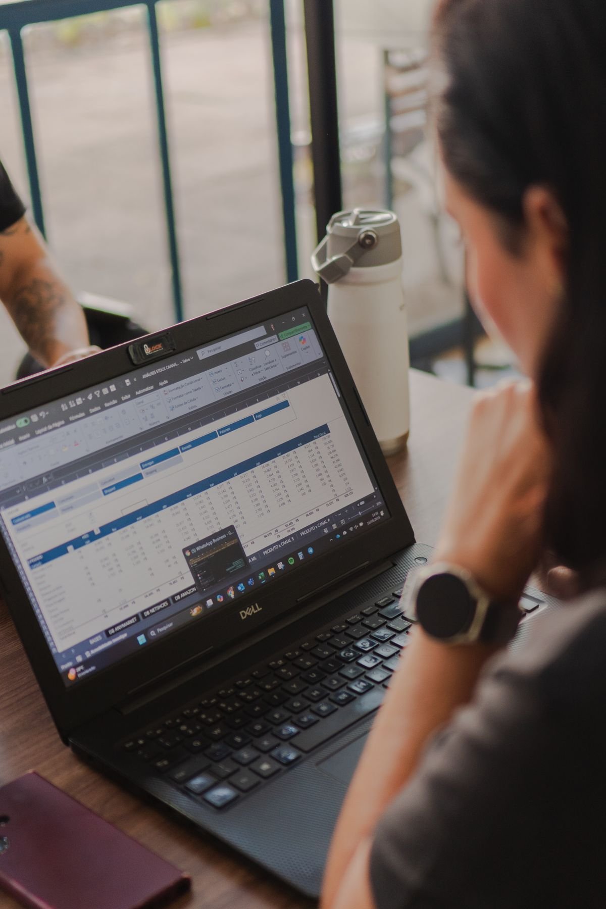 An engineer reviewing spreadsheet data on a laptop screen at a desk