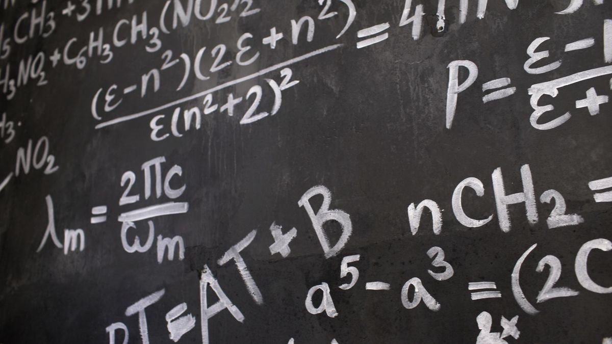 Complex equations and formulas written on a blackboard